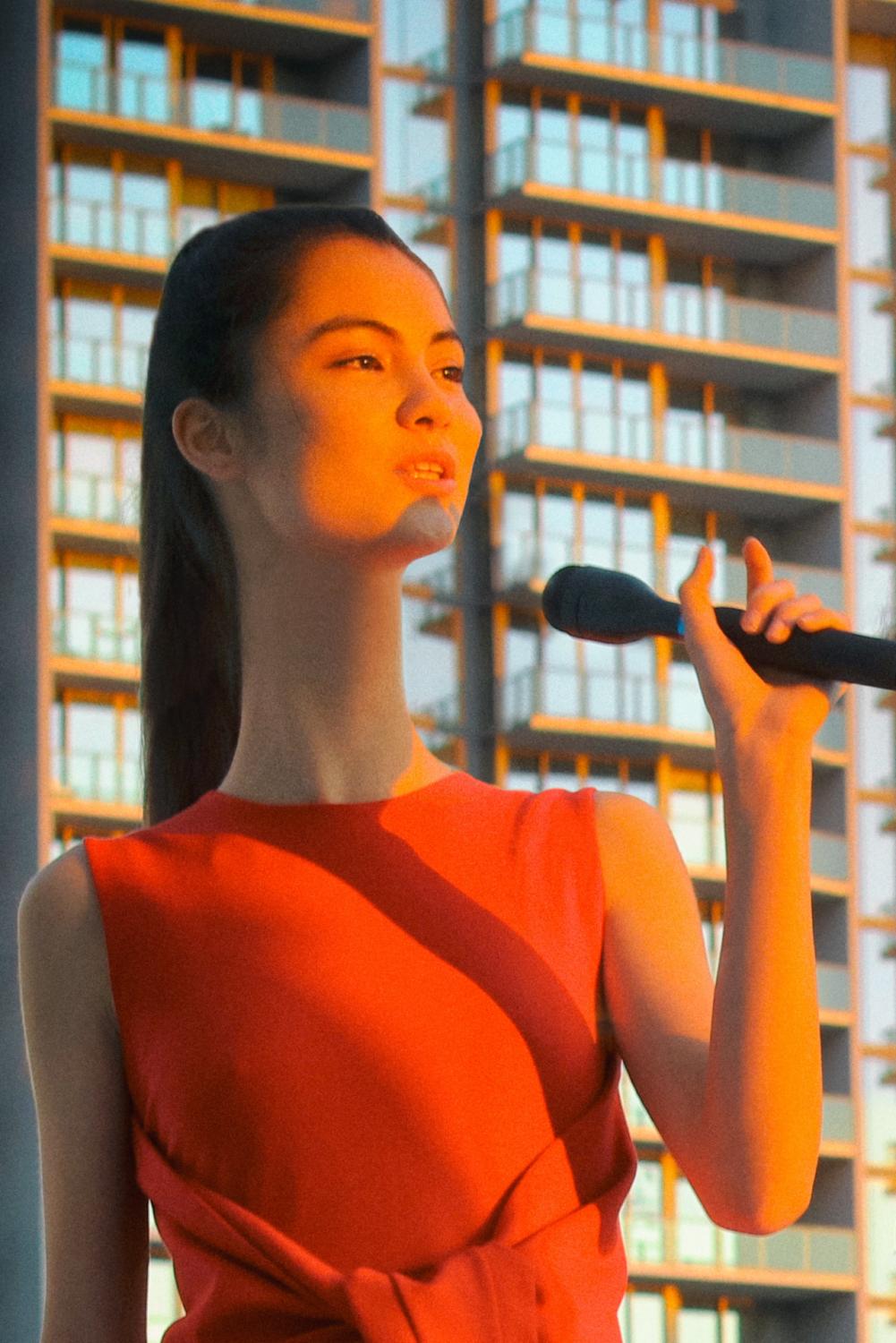 red dress, red top, long neck, black hair, black microphone