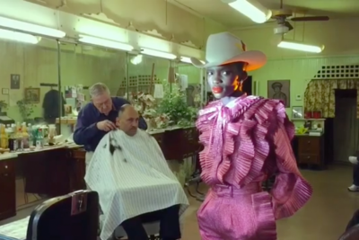 hair salon, mirrors, pink glitter outfit, red lipstick, cowboy hat